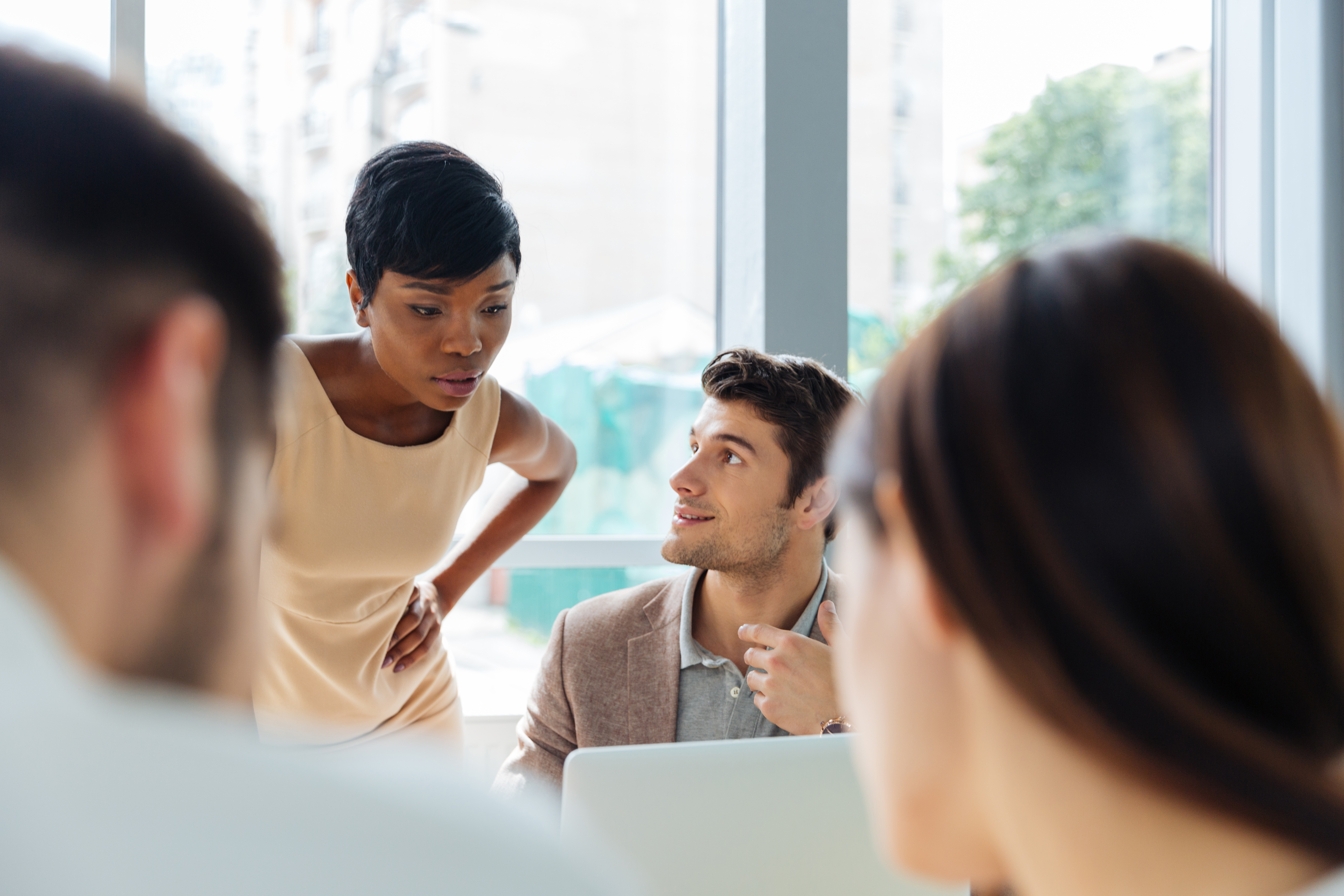 Happy young businesspeople at meeting in office